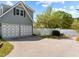 Two-car garage with white and gray doors and white fence at 11609 Us-401, Fuquay Varina, NC 27526
