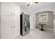 Updated kitchen with stainless steel refrigerator and white cabinetry at 11609 Us-401, Fuquay Varina, NC 27526