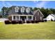 Brick home with a covered porch and beautifully landscaped yard at 107 Knottingham Ct, Dunn, NC 28334