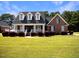 Brick home with a front porch and well-manicured lawn at 107 Knottingham Ct, Dunn, NC 28334