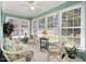 Sun-drenched sunroom with multiple windows and comfy seating at 107 Knottingham Ct, Dunn, NC 28334