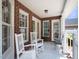 Front porch with white rocking chairs and wrought iron seating at 107 Knottingham Ct, Dunn, NC 28334
