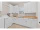 Bright laundry room with white cabinets and a butcher block countertop at 3105 W Hampton Dr, Rocky Mount, NC 27804