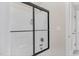 Modern shower with sliding glass door and black accents at 3105 W Hampton Dr, Rocky Mount, NC 27804
