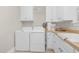 Bright laundry room with washer, dryer, and ample cabinetry at 3105 W Hampton Dr, Rocky Mount, NC 27804