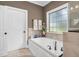 Relaxing bathroom with a large soaking tub and window at 3105 W Hampton Dr, Rocky Mount, NC 27804