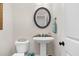 Small powder room with pedestal sink and oval mirror at 3105 W Hampton Dr, Rocky Mount, NC 27804
