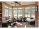 Bright sunroom featuring wicker furniture and brick walls at 3105 W Hampton Dr, Rocky Mount, NC 27804