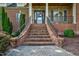 Brick front exterior with a charming staircase and landscaping at 3105 W Hampton Dr, Rocky Mount, NC 27804