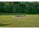 Landscaped backyard with birdbath and seating area at 3105 W Hampton Dr, Rocky Mount, NC 27804