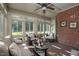 Bright sunroom featuring wicker furniture and brick walls at 3105 W Hampton Dr, Rocky Mount, NC 27804