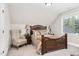 Charming bedroom with a comfortable bed and window seat at 3105 W Hampton Dr, Rocky Mount, NC 27804