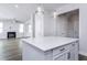 Modern kitchen island with white cabinets and quartz countertop at 5828 Genesee Dr., Homesite 9, Durham, NC 27712