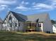 Rear view of a house featuring a wooden deck and gray siding at 35 Courtland Dr, Louisburg, NC 27549