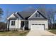 One-story house with gray siding, gray roof, and a two-car garage at 35 Courtland Dr, Louisburg, NC 27549