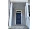Dark blue front door with white columns and stone steps at 35 Courtland Dr, Louisburg, NC 27549