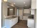 Modern kitchen with white cabinets, granite countertops, and stainless steel appliances at 35 Courtland Dr, Louisburg, NC 27549