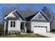 Gray siding, white trim, and a gray roof characterize this charming house at 35 Courtland Dr, Louisburg, NC 27549