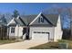 One-story house with gray siding, gray roof, and a two-car garage at 35 Courtland Dr, Louisburg, NC 27549