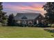 Brick ranch home with manicured lawn and beautiful sunset at 3313 Overhead Ct, Willow Springs, NC 27592