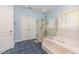 Spa-like bathroom featuring a walk-in shower and a large soaking tub at 3313 Overhead Ct, Willow Springs, NC 27592