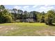 Serene backyard view showcasing a tranquil pond at 3313 Overhead Ct, Willow Springs, NC 27592
