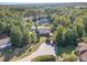 Home with pond and circular driveway, surrounded by trees at 3313 Overhead Ct, Willow Springs, NC 27592