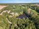 Aerial view of house with private pond and surrounding woods at 3313 Overhead Ct, Willow Springs, NC 27592