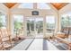 Sunroom with rocking chairs, access to a deck, and scenic views at 3313 Overhead Ct, Willow Springs, NC 27592