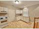 Well-equipped kitchen featuring white cabinets and wood flooring at 4418 Samantha Dr, Raleigh, NC 27613