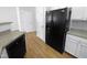 Kitchen boasts black appliances and light wood laminate flooring at 5107 Sandy Banks Rd, Raleigh, NC 27616