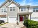 Attractive two-story townhome with a red front door and attached garage at 5107 Sandy Banks Rd, Raleigh, NC 27616