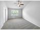 Bright bedroom with ceiling fan and plush carpeting at 5107 Sandy Banks Rd, Raleigh, NC 27616