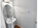 Simple pedestal sink and toilet in small bathroom at 5107 Sandy Banks Rd, Raleigh, NC 27616