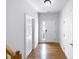 Light and airy entryway with hardwood floors and white doors at 5107 Sandy Banks Rd, Raleigh, NC 27616