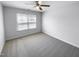 Simple bedroom with neutral carpeting and a window with blinds at 5107 Sandy Banks Rd, Raleigh, NC 27616