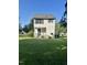 Rear view of a white two-story house with a yard at 44 Wallace St, Angier, NC 27501