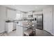 Modern kitchen with white cabinets, granite countertops, and stainless steel appliances at 79 Lawnview Ct, Fuquay Varina, NC 27526