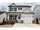 Two-story house with white siding, gray trim, and a brick base at 149 Greenview St, Clayton, NC 27520