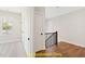 Upstairs hallway with hardwood floors and railing at 100 Firefly Ln, Louisburg, NC 27549