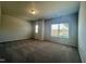 Spacious bedroom with large window and carpet flooring at 256 Bruce Dr, Dunn, NC 28334