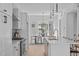 Modern kitchen with white cabinets, stainless steel appliances, and breakfast bar at 3005 Corbell Rd, Durham, NC 27701