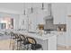 Modern kitchen with white cabinets, large island and open to living area at 3005 Corbell Rd, Durham, NC 27701