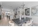 Open concept dining room with modern table and kitchen views at 3005 Corbell Rd, Durham, NC 27701