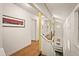 Bright hallway with hardwood floors, yellow columns, and modern art at 4416 Arrowhead Trl, Hillsborough, NC 27278