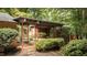 Modern covered walkway with red columns and lush landscaping at 4416 Arrowhead Trl, Hillsborough, NC 27278
