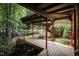Unique wooden walkway leading to home with red columns at 4416 Arrowhead Trl, Hillsborough, NC 27278