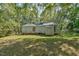 Rear view of a ranch home with a shed and landscaping at 185 Weatherbend, Pittsboro, NC 27312