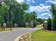 Another view of the entrance to Norwood Ridge, featuring a stone and wrought iron gate at 5828 Norwood Ridge Dr, Raleigh, NC 27614