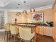 Basement wet bar with wood cabinets, granite countertop, and pendant lighting at 50211 Manly, Chapel Hill, NC 27517